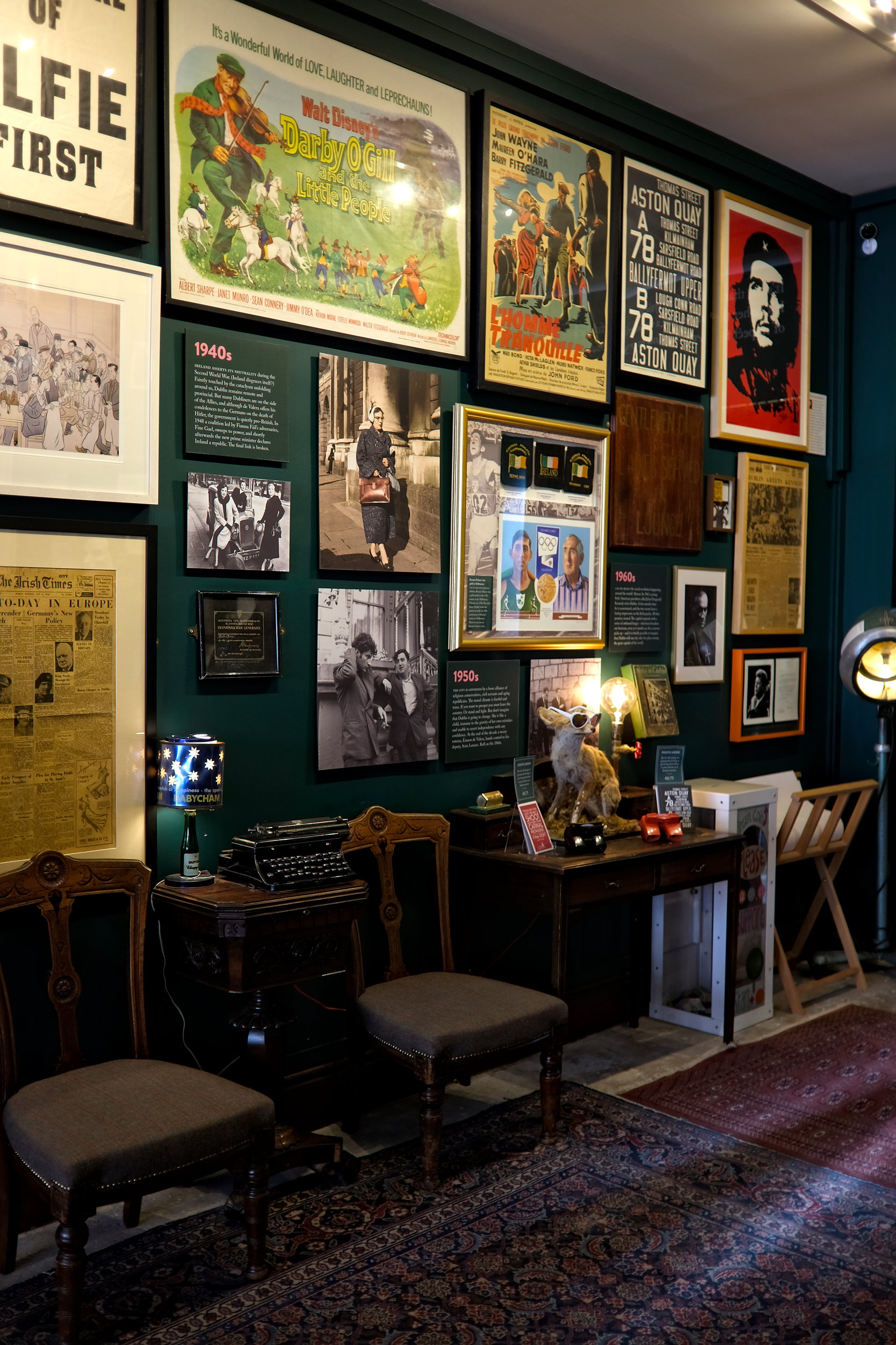 A wall of eclectic artifacts and posters detailing Dublin's history at The Little Museum of Dublin