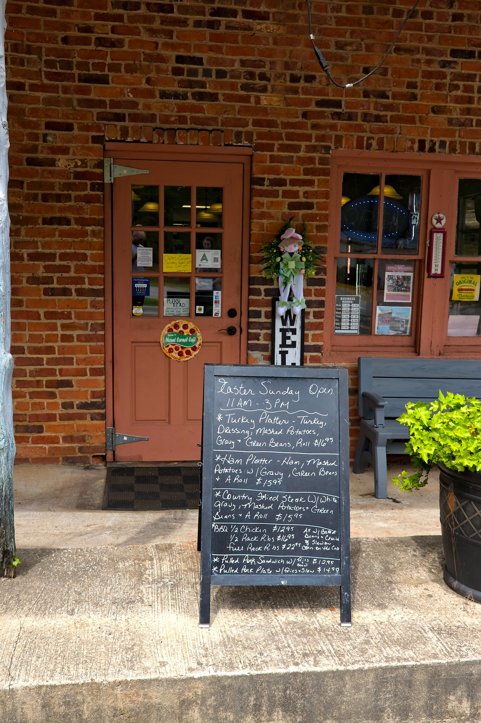 The menu board with specials outside of Mount Carmel Cafe