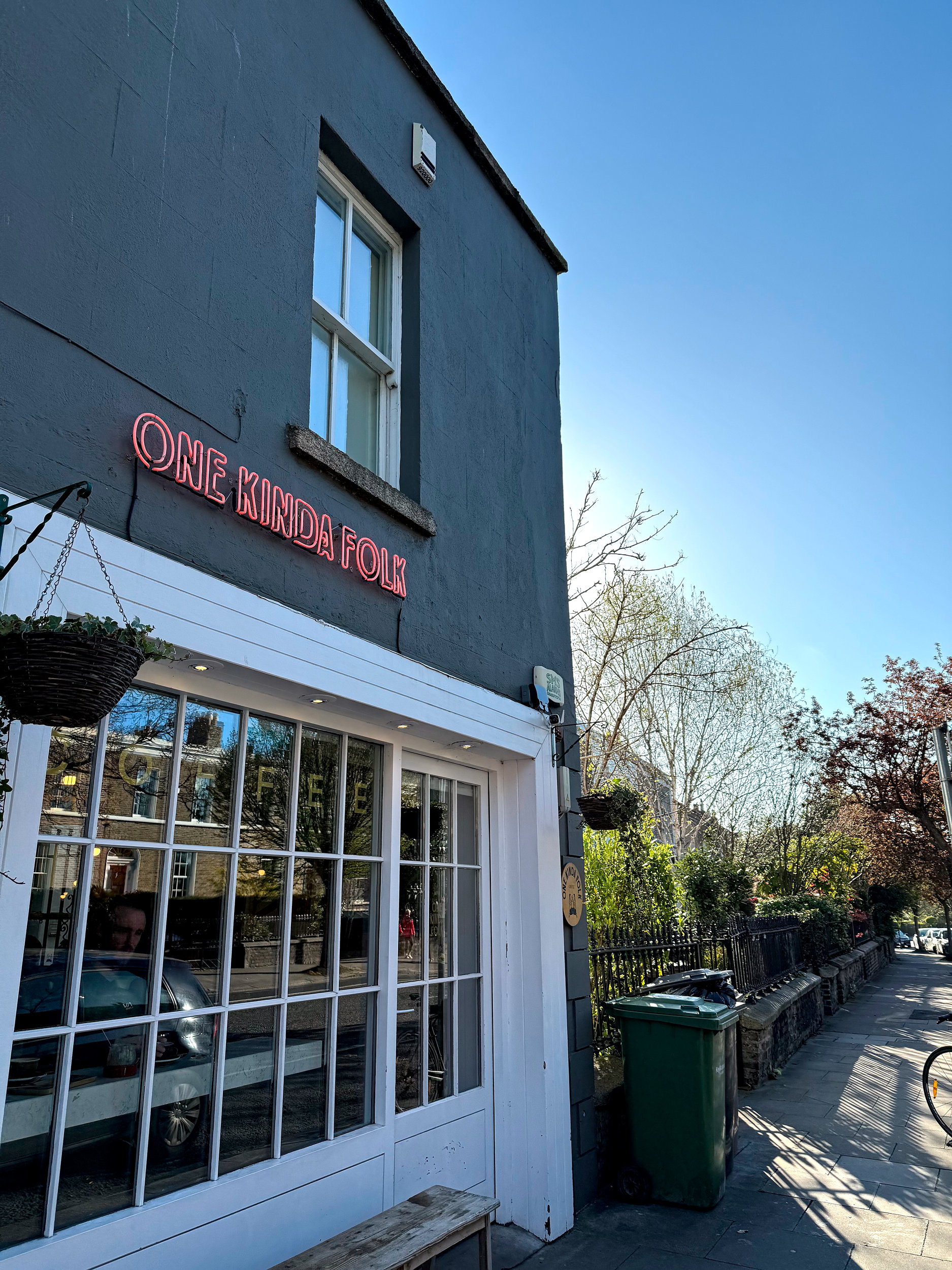 The exterior of One Kinda Folk in Dublin, which has a charcoal front and red neon signage