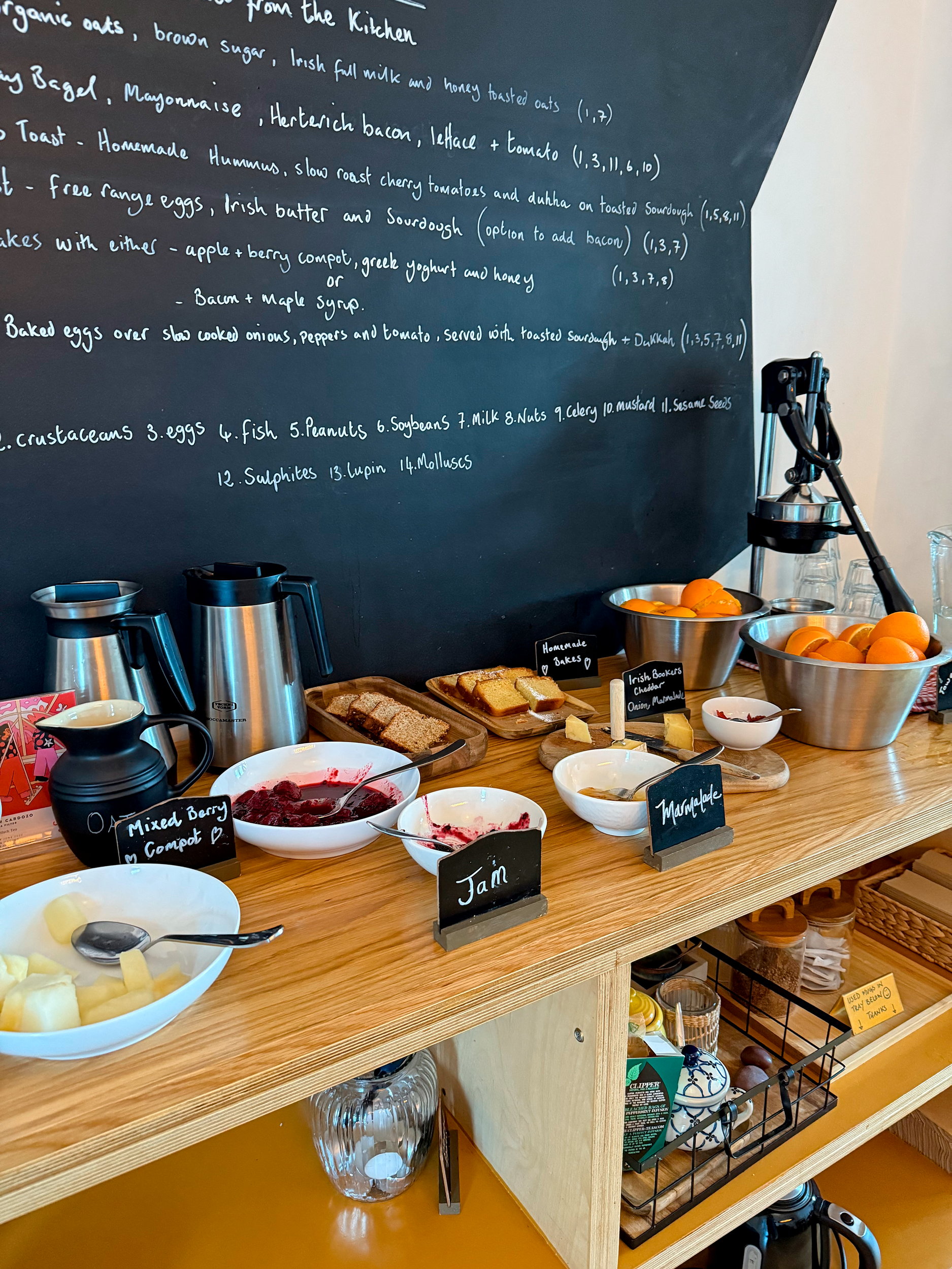 A counter loaded with jam, butter, home bakes, and an orange juicer at The Stop in Galway