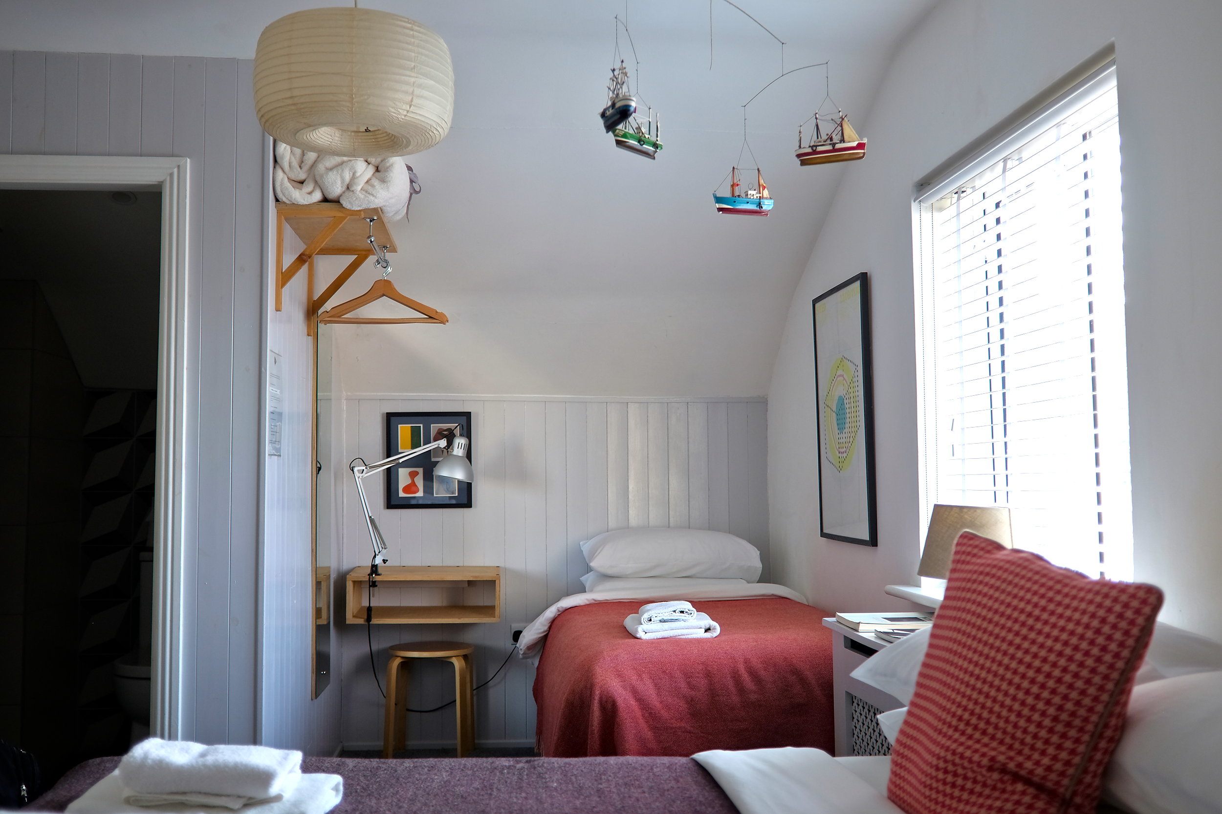 The Family Room at The Stop, and two of the three beds are visible