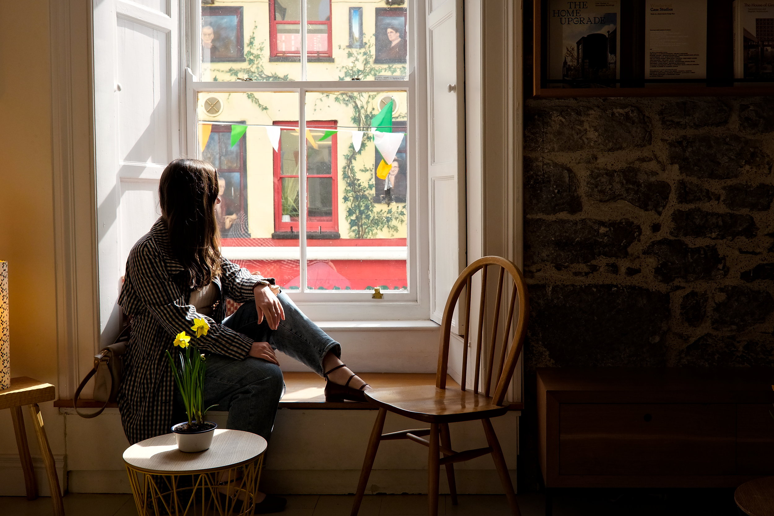 Alyssa sits in a window seat in Galway