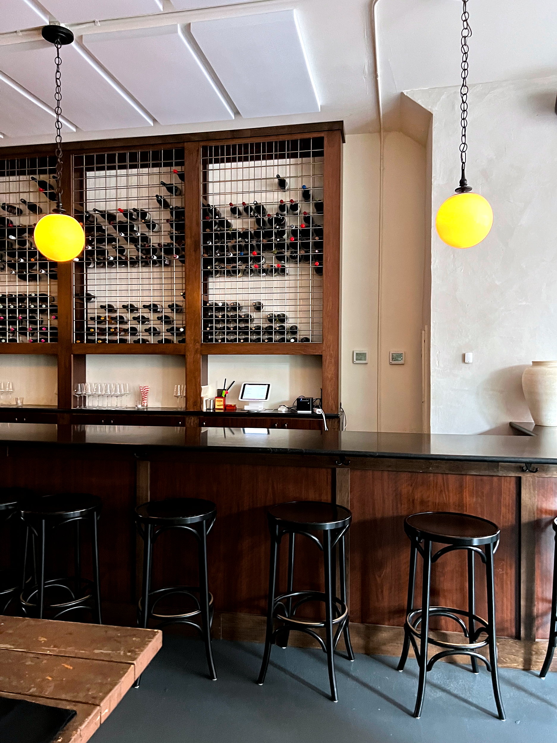 Wine bottles encased behind the bar at Bar à Vins