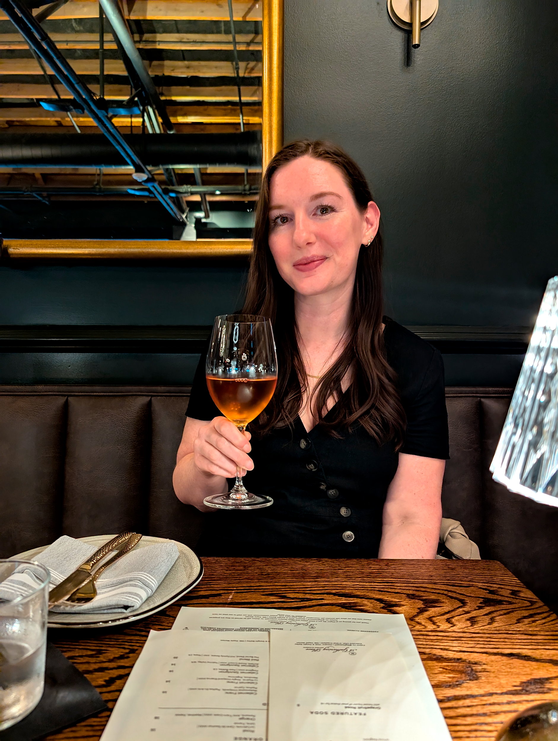 Alyssa with a glass of wine at Flight