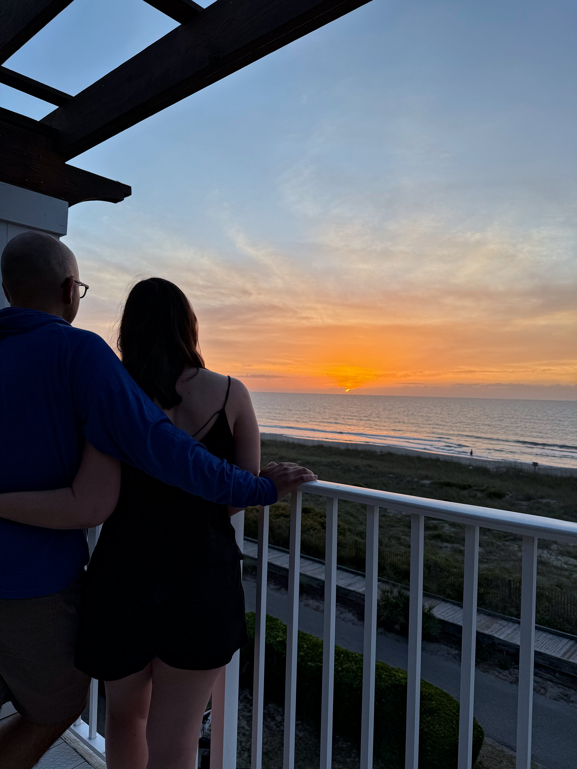 Alyssa and Michael watch the sunrise over Kure Beach