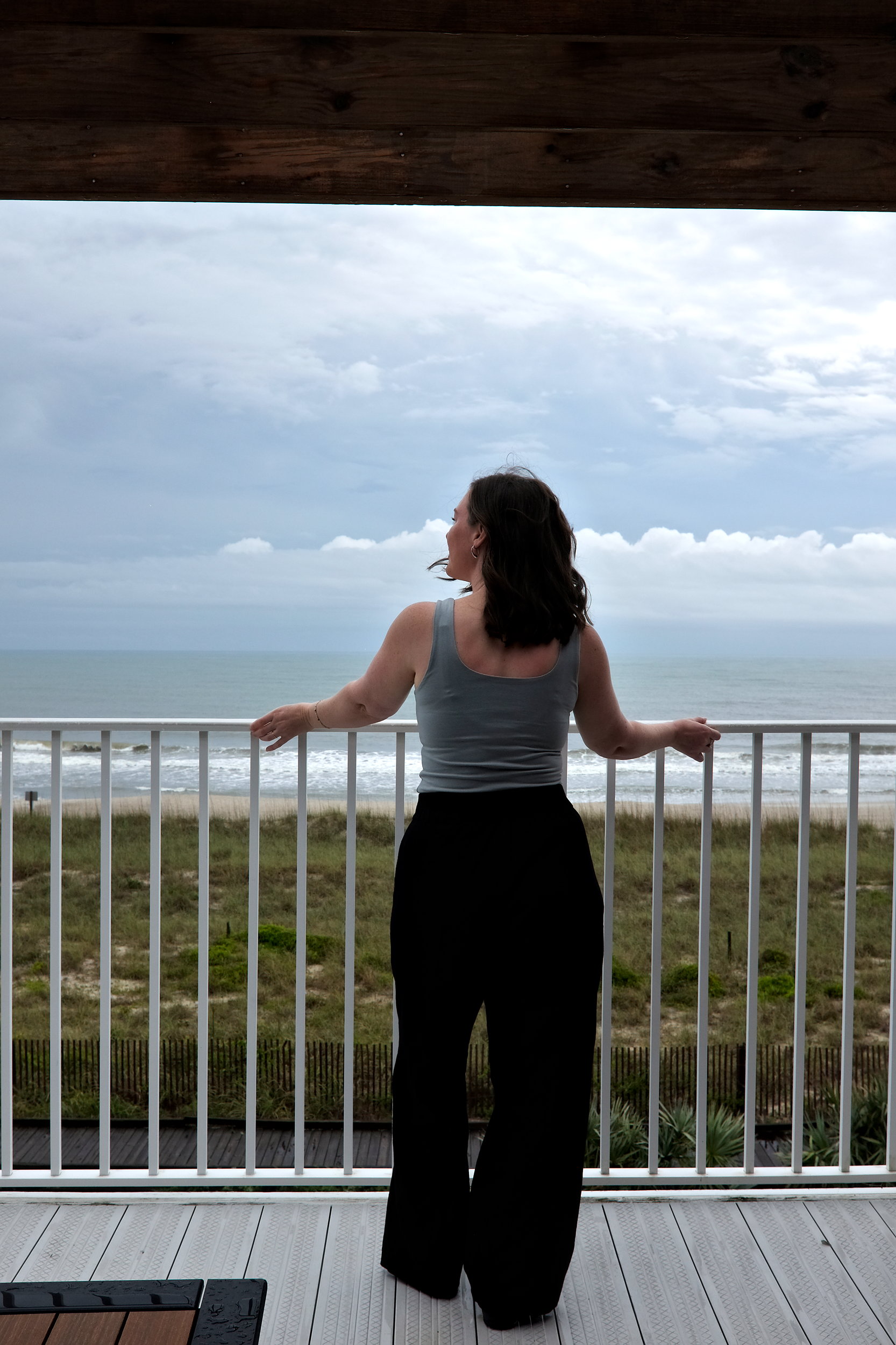 Alyssa looks out from the balcony over Kure Beach